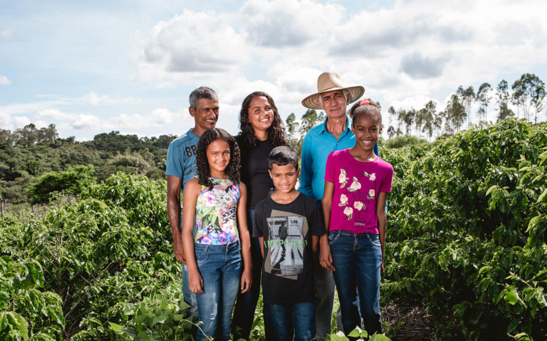 Farmer Family standing in coffee field