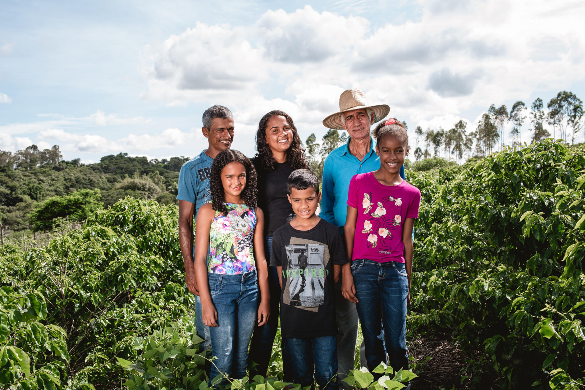 Farmer Family standing in coffee field